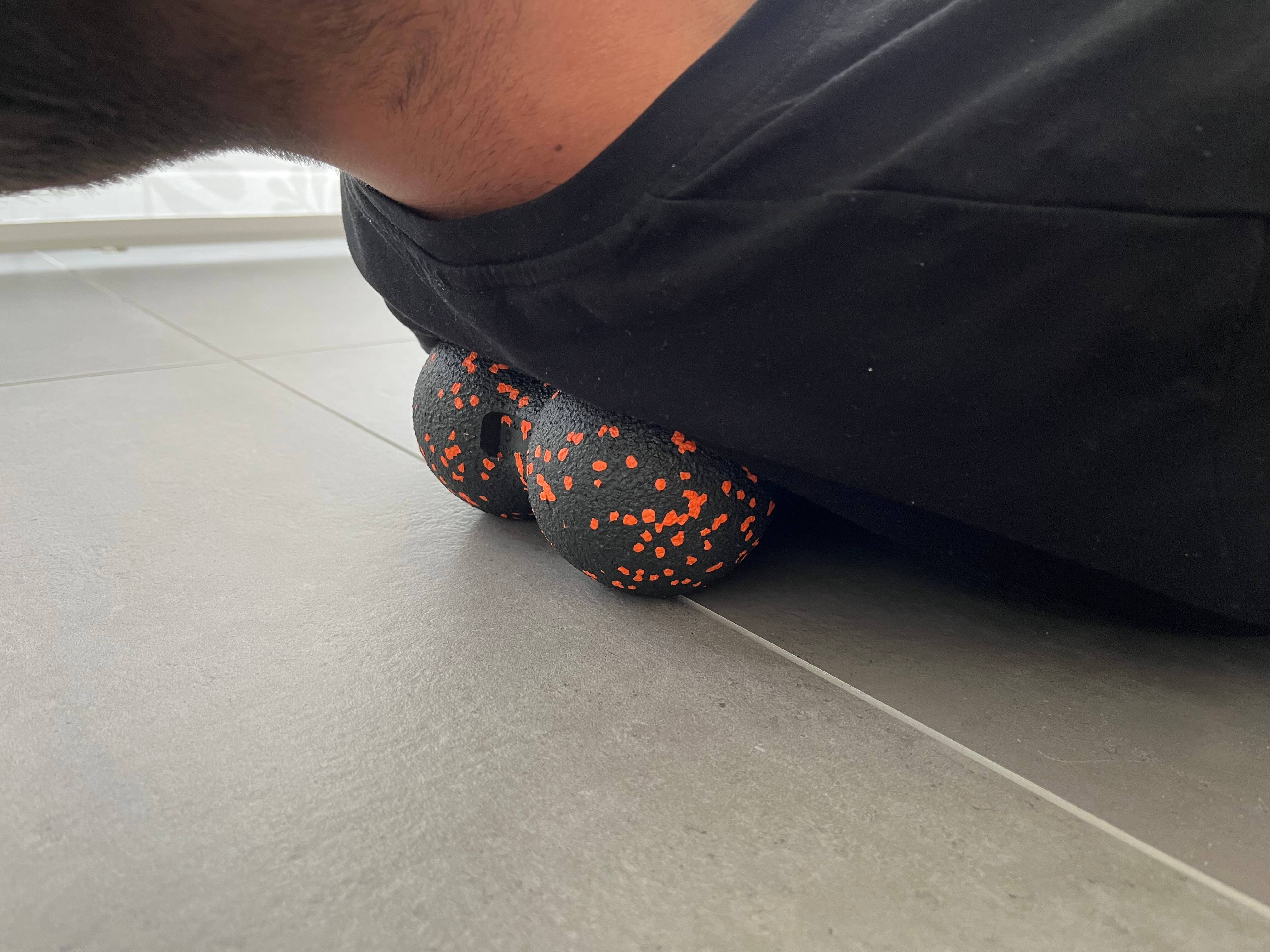 Mann macht Übung mit Duoball für den Nacken